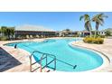 Community pool featuring crystal-clear water, comfortable lounge chairs, and well-maintained brick pavers at 8996 Excelsior Loop, Venice, FL 34293