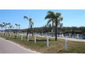 Picturesque waterfront promenade featuring palm trees and decorative flower pots, offering a serene view of the marina at 10315 Cortez W Rd # 1G, Bradenton, FL 34210