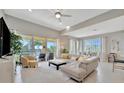 Bright living room featuring a large sectional sofa, balcony access, and lake views at 1235 Riverscape St # 1235, Bradenton, FL 34208