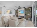 Bright living room featuring a modern fireplace, ceiling fan, and cozy furniture at 14061 Heritage Landing Blvd # 412, Punta Gorda, FL 33955
