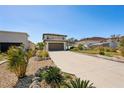 Long driveway leading to a two-story home with well-maintained landscaping and a spacious yard at 1876 Livingstone St, Sarasota, FL 34231