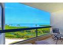 Relaxing balcony with scenic water views, complete with comfortable seating at 1930 Harbourside Dr # 136, Longboat Key, FL 34228
