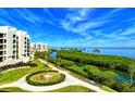 Exterior view of the condo buildings showcasing the beautiful landscaping and waterfront views at 1930 Harbourside Dr # 136, Longboat Key, FL 34228