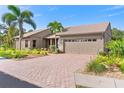 Attractive home showcasing a two-car garage and brick-paved driveway at 2408 89Th Nw St, Bradenton, FL 34209