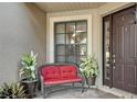 Charming front porch featuring a cozy bench and decorative plants, creating a welcoming entrance to the home at 2512 61St E Ave, Ellenton, FL 34222