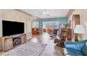 Open-concept living area featuring a large tv, tile flooring, and bright, natural light at 2566 Tulip St, Sarasota, FL 34239