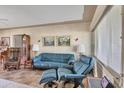 Comfortable living room featuring leather seating, a tall clock, and a bright window at 2566 Tulip St, Sarasota, FL 34239