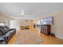 Spacious living room with hardwood floors, ceiling fan, and a cozy seating area at 2905 Bougainvillea St, Sarasota, FL 34239