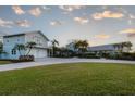 Inviting two story coastal home with lush landscaping, a circular driveway, and a two car garage at 336 S Orchid Dr, Ellenton, FL 34222