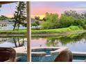 Relaxing pool view with calm water reflections and picturesque sunset at 3419 31St E St, Bradenton, FL 34208