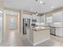 Modern kitchen with stainless steel appliances, granite countertops and white cabinets at 3835 Autumn Fern Ter, Sarasota, FL 34243