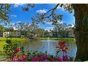 Scenic view of the condo community's pond featuring a fountain, gazebo and colorful floral landscaping at 425 30Th W Ave # C201, Bradenton, FL 34205
