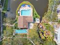 An aerial view of the community pool, deck, and the beautiful landscaping of this lovely condominium at 515 30Th Ave W # H410, Bradenton, FL 34205