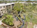 Aerial view of the property's landscaped grounds, including seating area and winding stream at 515 30Th Ave W # H410, Bradenton, FL 34205