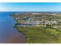 Aerial view of waterfront condos near the water with lush landscape and scenic views at 515 Leffingwell Ave # 210, Ellenton, FL 34222