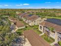 Aerial view of condos with solar panels and landscaped grounds in a serene neighborhood at 5211 Mahogany Run Ave # 126, Sarasota, FL 34241