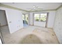 Light-filled bedroom with sliding glass doors, a large window, and traditional wallpaper at 5684 Sheffield Greene Cir # 79, Sarasota, FL 34235