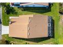 Aerial view of house with brown roof, screened in lanai, and well maintained lawn at 5814 Garden Lakes Fern, Bradenton, FL 34203