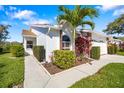 Charming home with beautiful lawn, palm tree, and stone accent features on the front exterior at 5814 Garden Lakes Fern, Bradenton, FL 34203