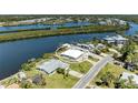 Single-story waterfront home boasting lush lawn, a private dock, and a serene canal view at 603 Ravenna N St, Nokomis, FL 34275