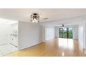 Bright living room with hardwood floors and sliding door to the balcony at 6124 43Rd W St # 404A, Bradenton, FL 34210