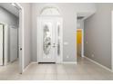Bright and spacious foyer with tiled flooring and decorative glass front door and coat closet at 7351 Meeting St, Bradenton, FL 34201
