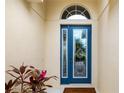 Stylish blue front door with decorative glass and transom window, enhancing curb appeal at 7351 Meeting St, Bradenton, FL 34201