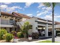 Charming condo with covered parking, lush plants, and a cozy, inviting entrance at 756 Avenida Estancia # 162, Venice, FL 34292