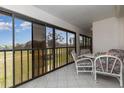 Relaxing screened patio with tile flooring and seating area overlooking lush green space at 756 Avenida Estancia # 162, Venice, FL 34292