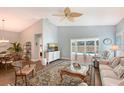 Comfortable living room with wood floors and access to the pool, perfect for relaxing and entertaining at 7767 Pine Trace Dr, Sarasota, FL 34243