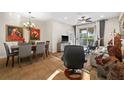 Open-concept living and dining area with tile floors and sliding door access to the outdoors at 7959 Limestone Ln # 14-104, Sarasota, FL 34233