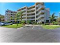 Multi-story condo building featuring open-air staircases, balconies, and lush tropical landscaping at 835 S Osprey Ave # 101, Sarasota, FL 34236