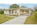 This home features a carport and a side entry, complemented by a well-kept lawn and landscaping at 108 21St Ne St, Bradenton, FL 34208
