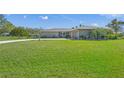 Lush green lawn enhancing the curb appeal of this charming single-story home at 1208 Angela Maria Rd, Sarasota, FL 34243