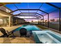 Relaxing screened-in pool and spa overlooking a peaceful pond with stunning sunset views, perfect for outdoor entertaining at 16455 Whale Grey Pl, Bradenton, FL 34211