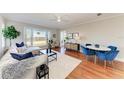 Bright living room featuring hardwood floors, a comfortable couch, and an ocean view from the large windows at 2512 Riverside E Dr, Bradenton, FL 34208