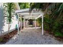Covered carport featuring a gravel driveway, providing shade and protection for vehicles at 2530 Loma Linda St, Sarasota, FL 34239