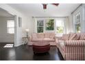 Bright living room featuring striped sofas, dark wood floors, and ample natural light at 2530 Loma Linda St, Sarasota, FL 34239