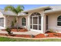 Inviting front entrance with elegant architectural details, manicured landscaping, and a well-lit walkway at 4268 Mulgrave Ave, North Port, FL 34287