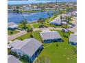 Aerial shot showcasing a lovely home with a screened lanai overlooking lush landscaping and waterway at 4411 Mount Vernon Dr, Bradenton, FL 34210