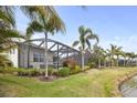 Screened-in patio with beautiful landscaping and a tranquil water view, perfect for relaxing outdoors at 4691 Claremont Park Dr, Bradenton, FL 34211