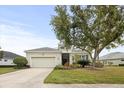 Inviting single-story home with a well-maintained lawn, driveway, garage and landscaping at 4691 Claremont Park Dr, Bradenton, FL 34211