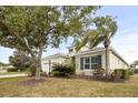Well-maintained home with a landscaped front yard featuring a variety of plants and trees at 4691 Claremont Park Dr, Bradenton, FL 34211