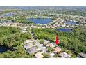 Aerial view of a charming community with a large lake, mature trees, and well-spaced houses at 4740 Carrington Cir, Sarasota, FL 34243