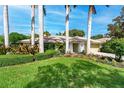 Charming home with mature landscaping, brick driveway, and lush green lawn at 4852 Peregrine Point N Cir, Sarasota, FL 34231