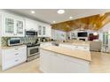 Bright kitchen with white cabinetry, stainless steel appliances, and view to the living room at 4852 Peregrine Point N Cir, Sarasota, FL 34231