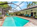 Screened-in pool area with lounge chairs and outdoor dining, perfect for relaxing at 4852 Peregrine Point N Cir, Sarasota, FL 34231