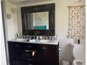 Stylish bathroom with a double vanity, framed mirror, and seashell décor at 5180 Guava Ter, Port Charlotte, FL 33981