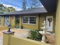 Inviting entrance showcasing a decorative fountain, tasteful landscaping, and modern exterior lighting at 5180 Guava Ter, Port Charlotte, FL 33981