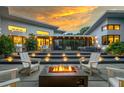 Beautiful backyard space with a fire pit, lounge seating, and a covered patio for outdoor entertaining at 587 47Th St, Sarasota, FL 34234